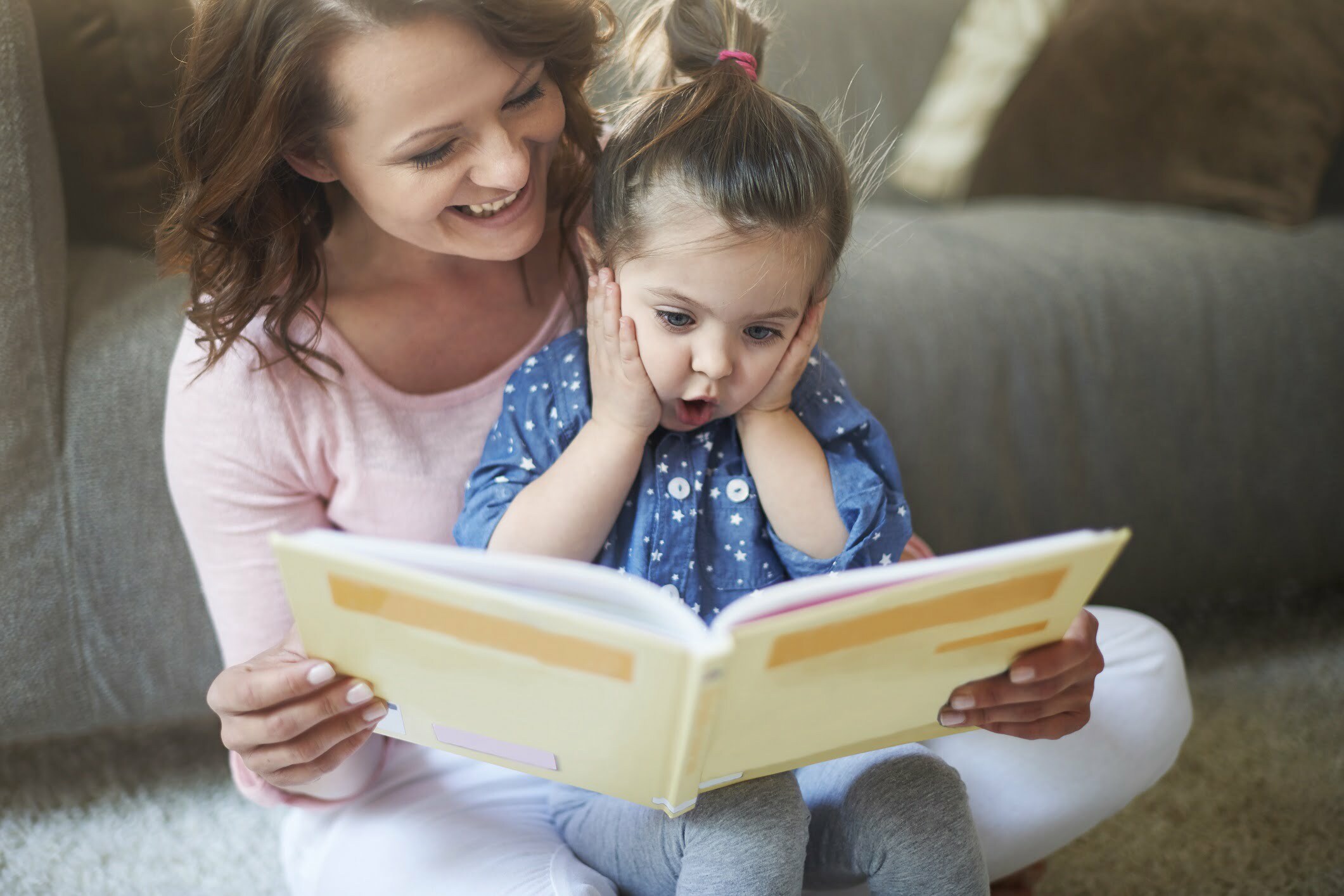 mother reading to surprised daughter-Gpointstudio
